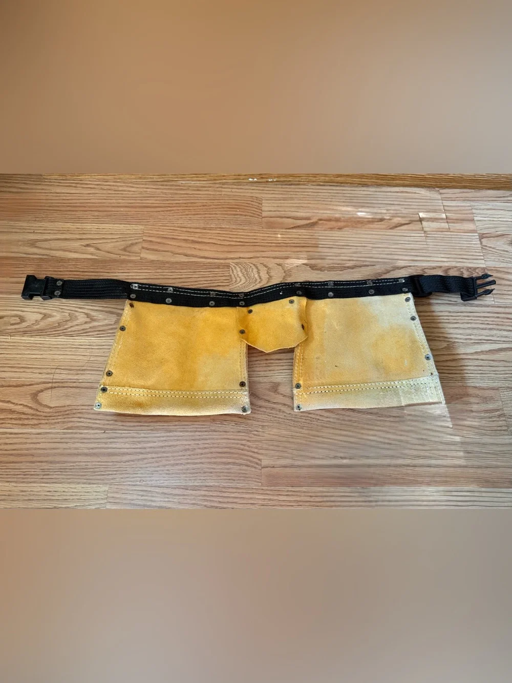 Suede leather Tool-belt that says ”Daddy Helper”n large gold letters in front.